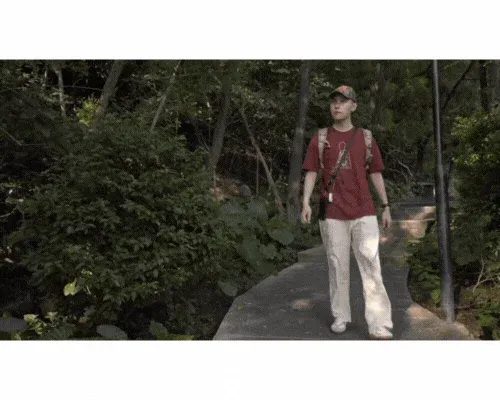 男性がストラップをつけて歩く様子