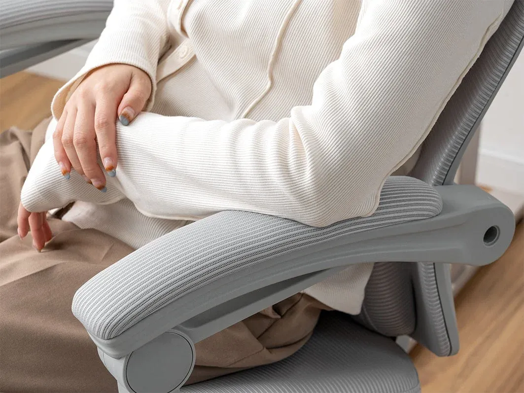 オフィスチェアに座っている人物の腕と上半身