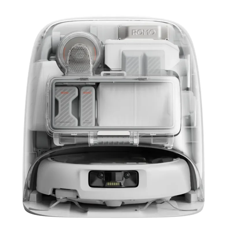 ロボット掃除機の自動クリーニングステーションを透明なケース越しに捉えた画像です。洗浄液と床用消臭剤のカートリッジが見え、本体のメンテナンス機能が強調されています。